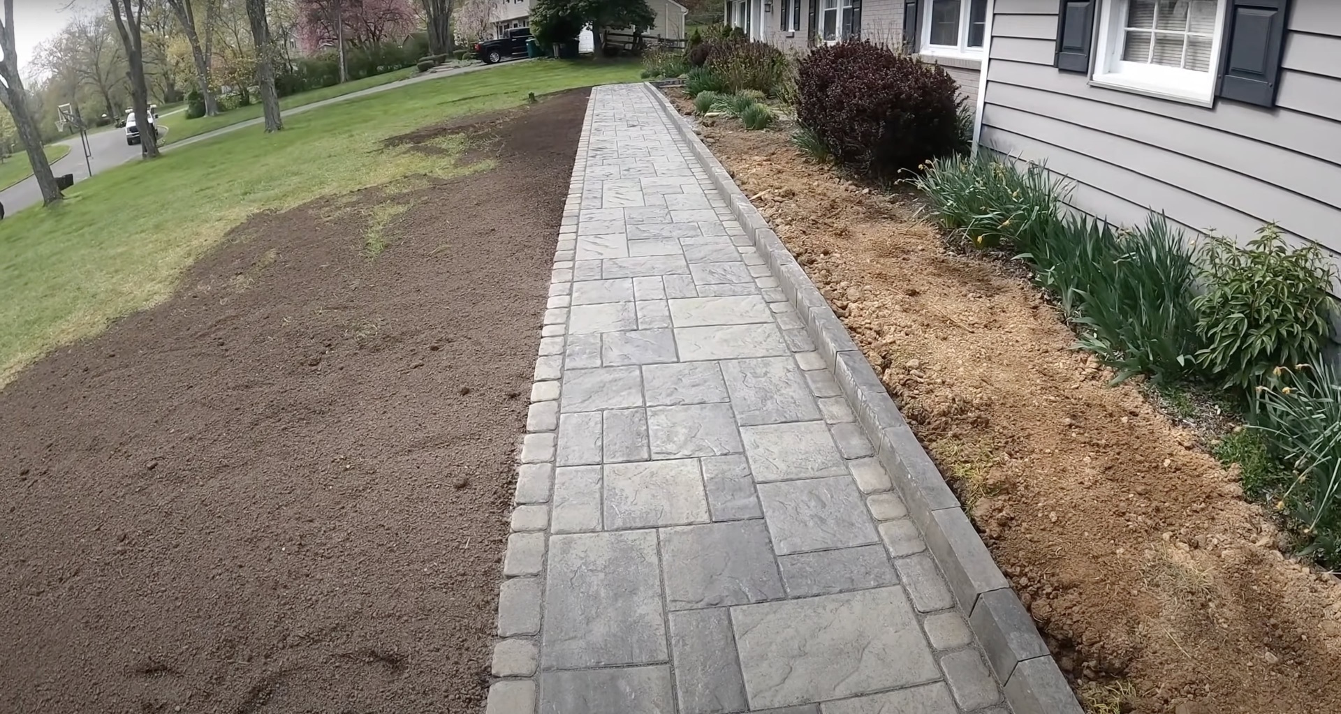 Professional stamped concrete walkway installation with natural stone pattern and clean edges