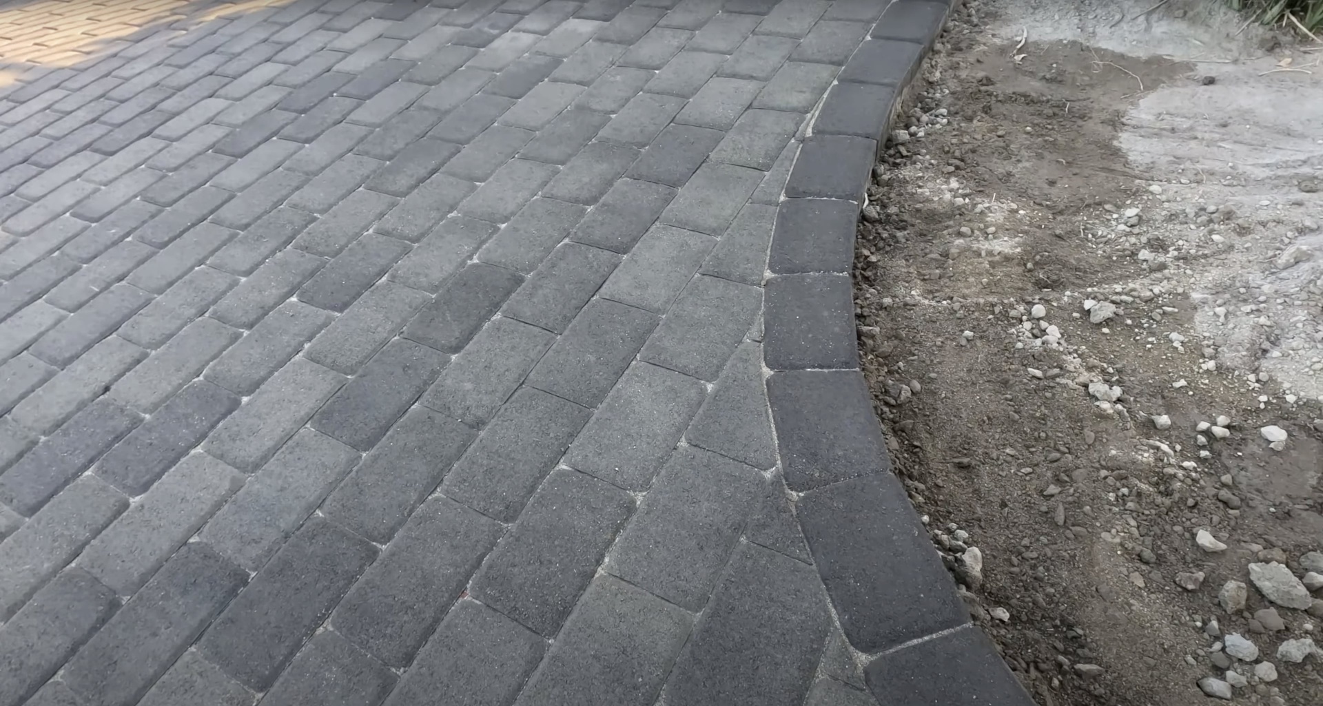 High-quality concrete paver installation with interlocking pattern and professional edge finishing