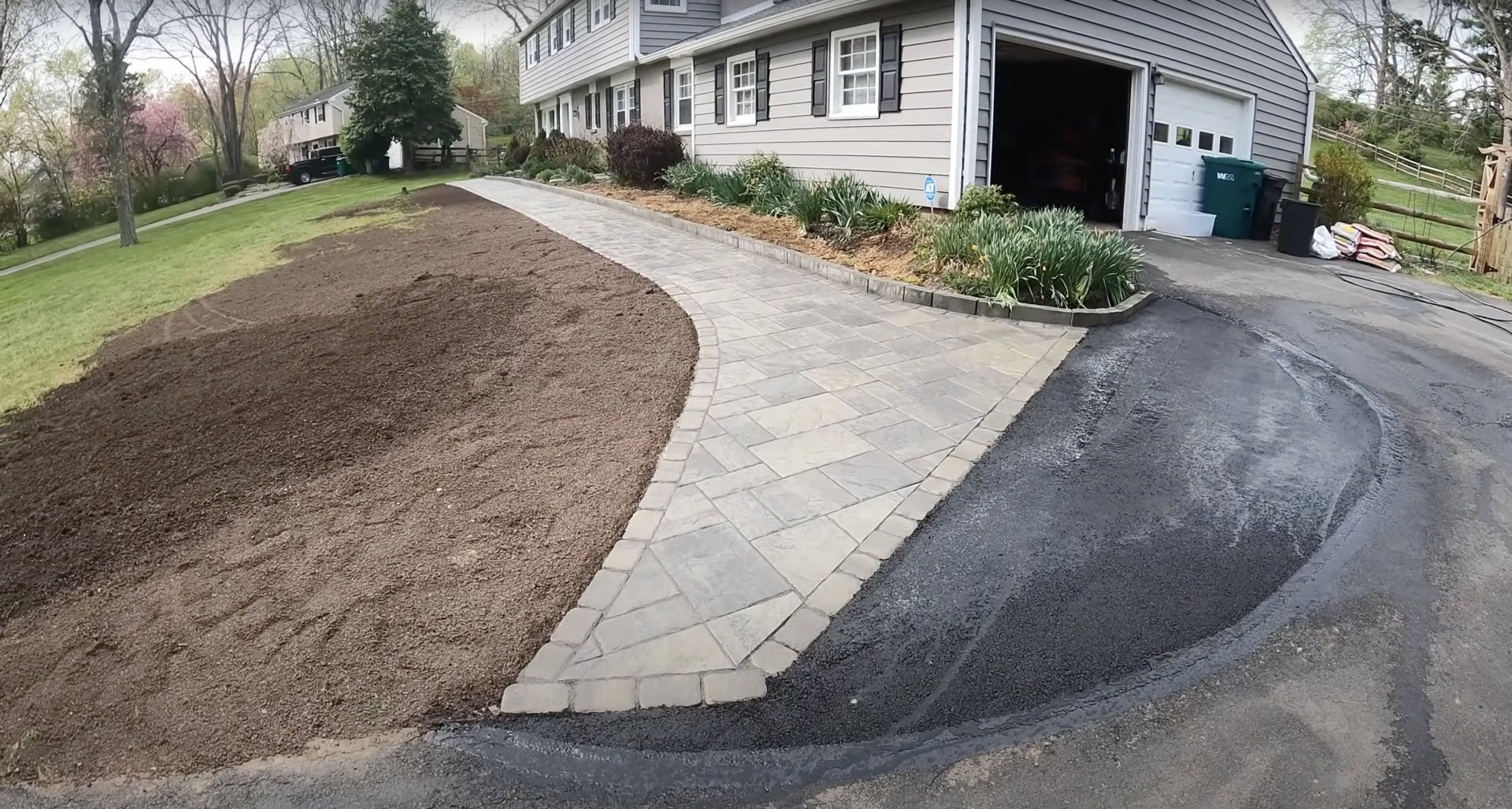 Elegant stamped concrete walkway and driveway installation with decorative paver patterns