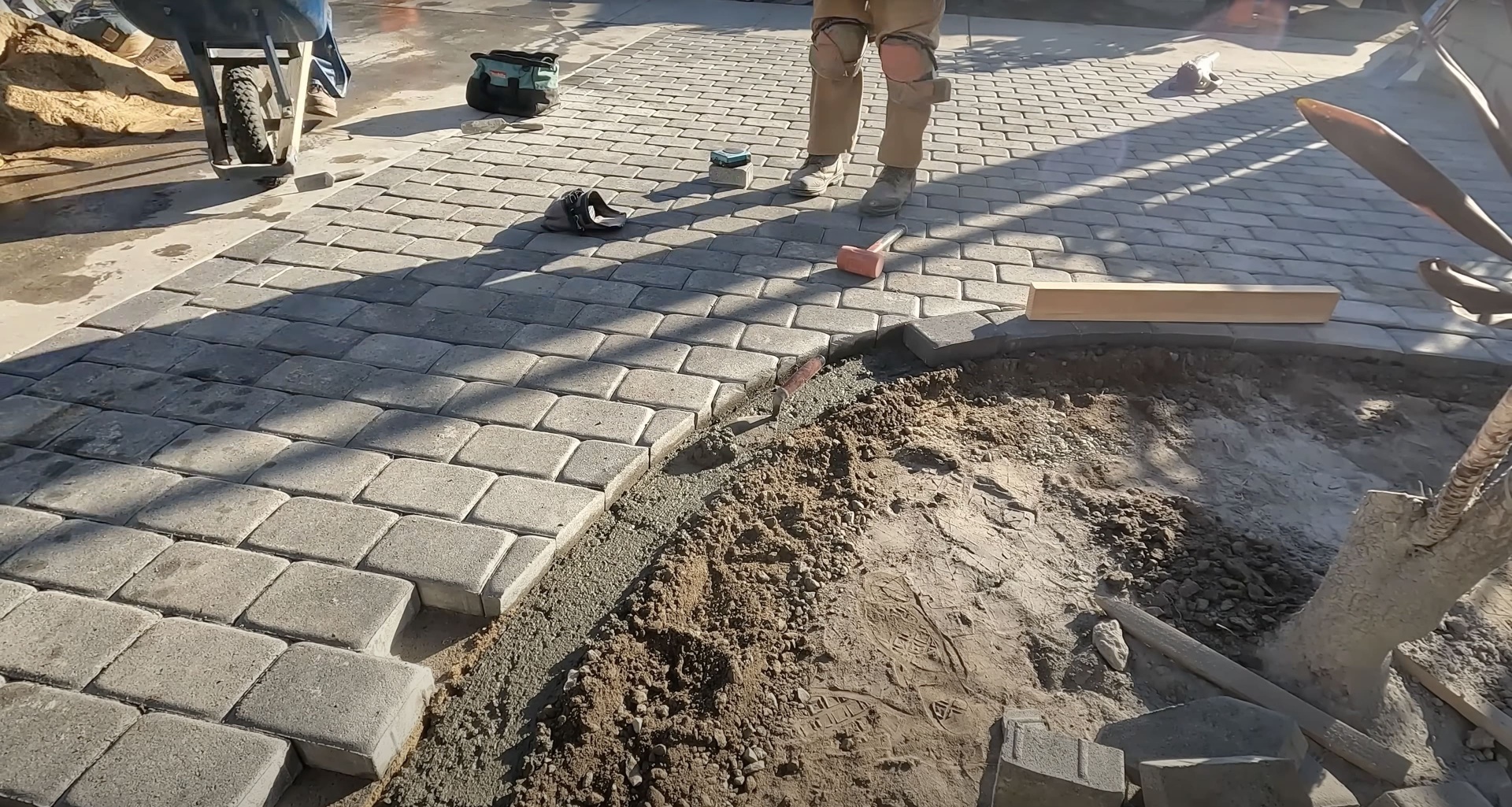 Professional concrete paving installation with workers using specialized equipment