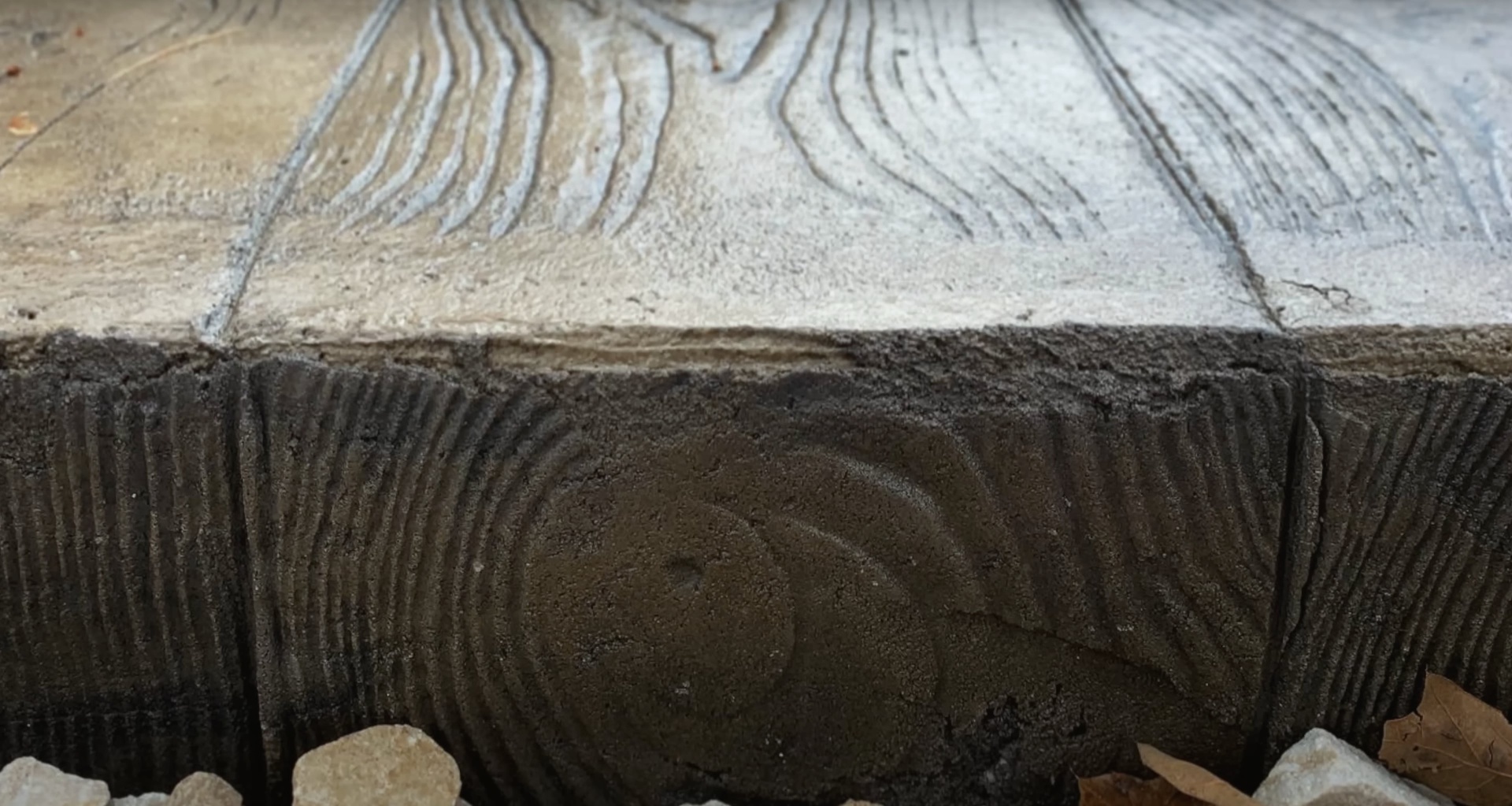 Detailed view of wood-textured stamped concrete showing realistic grain patterns and professional finishing